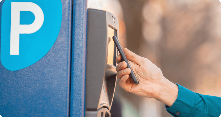 A contactless payment made with a phone at an unattended parking kiosk.
